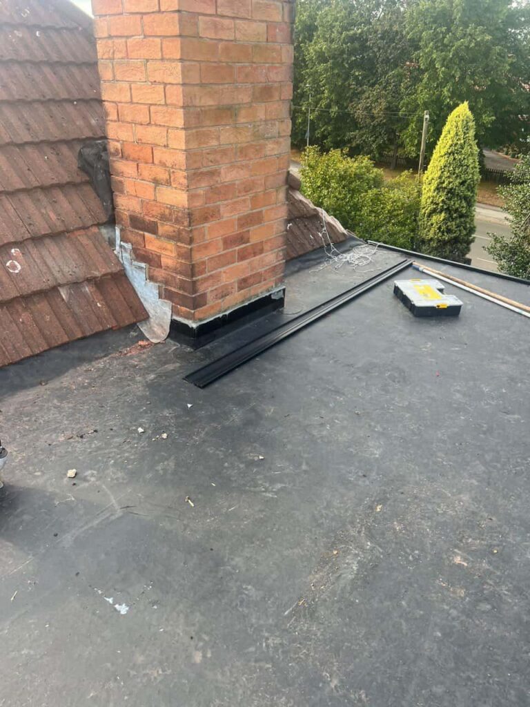 This is a photo of a flat roof which has just been repaired, there is also a chimney stack and some leadwork has also been dressed. Works carried out by Radford Roofing Repairs